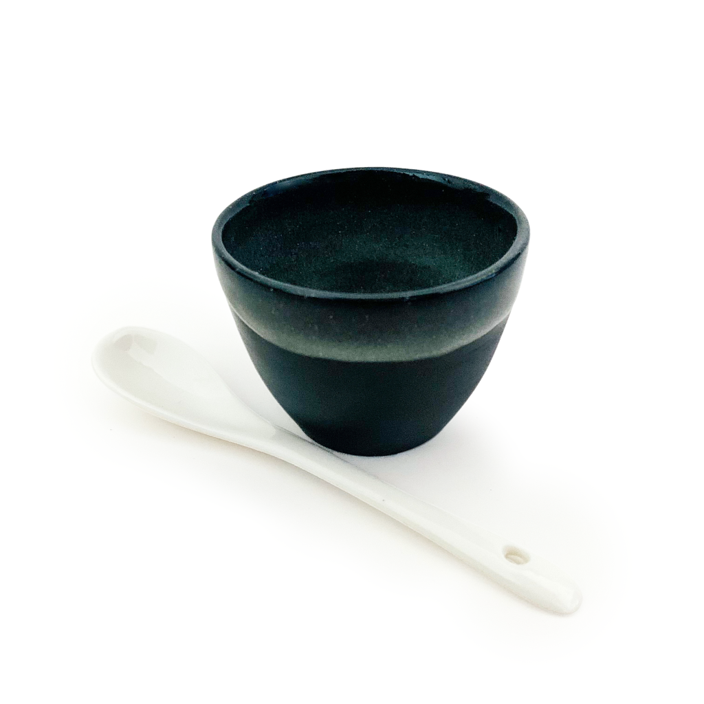 Cosmic Treatment Bowl - Hand Made Black Clay Bowl - Non Metallic Ceramic Mud Mask Mixing Bowl - with Ceramic Teaspoon side view - Oasis Black - Organic Botanical Skincare Featuring Black Seed Oil, Born in Morocco, Made in Byron Bay